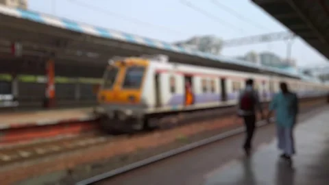 Bokeh view of suburban train at Tilaknagar station, Mumbai, India. Stock Footage 311774241