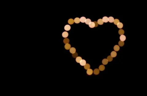 Bokeh warm lights. Beautiful St. Valentine's Day background. Stock Photos
