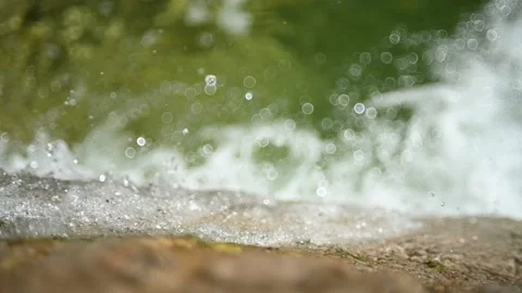 Bokeh from water falling into a pool (slow motion) Video stock 219635222