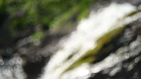 Bokeh of a waterfall in the mountains Stock Footage 219353027
