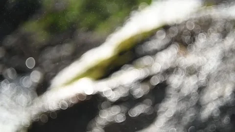 Bokeh of a waterfall in the mountains (slow motion) Stock Footage 219352756