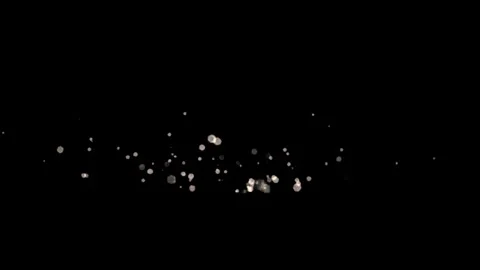 Bokeh white particles overlay layer blurry glitter on black background animation Video stock 299542529