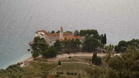 Bol on Brac island. Monastery on pebble beach in Bol view, island of Brac Stock-Footage 221705439
