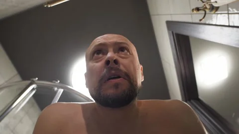 Bold and bearded man washes his face in attempt to back in mind Video stock 138202732