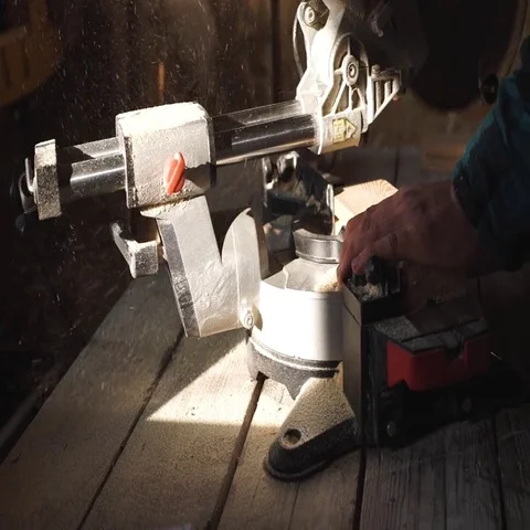Bold carpenter with moustache Using Circular Saw for wood in his workshop close Stock Footage 69537721