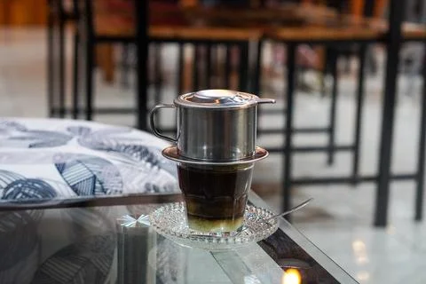 Bold coffee slowly brewed using a metal drip filter Stock Photos
