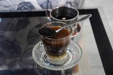 Bold coffee slowly brewed using a metal drip filter Stock Photos