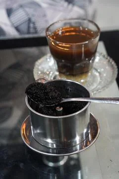 Bold coffee slowly brewed using a metal drip filter Stock Photos