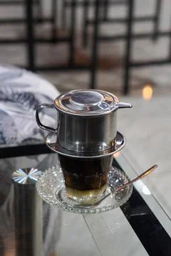 Bold coffee slowly brewed using a metal drip filter Stock Photos