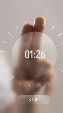 Bold digital artwork. Hand with two fingers pressing futuristic digital timer Foto stock