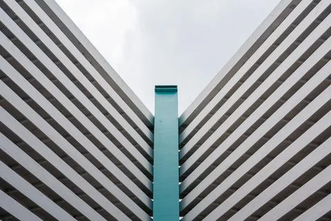 Bold geometric lines frame a striking teal column Stock Photos