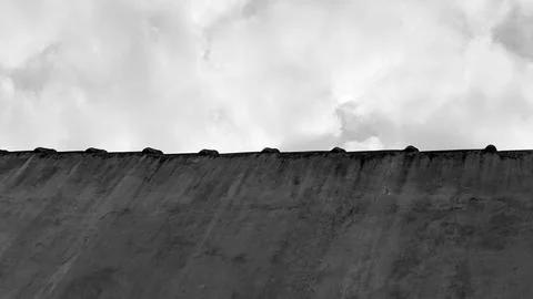 A bold horizontal monochrome low angle perspective captures a dark weathere.. Stock Photos