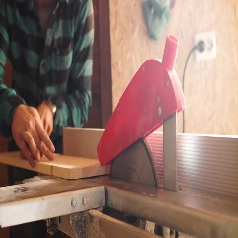 Bold with moustache Carpenter Man cutting wood plank using electric jig saw Stock Footage 69536606