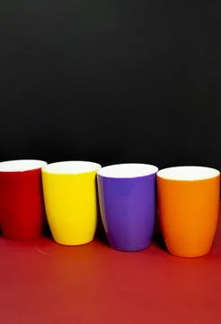 Bold Multicolor Cups Stacked on Black and Red for Branding Foto stock