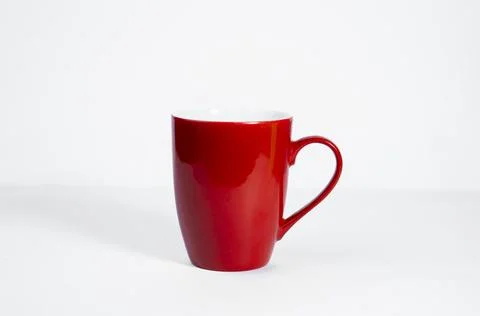 Bold Red Ceramic Tea Mug with Handle in White Studio Light Stock Photos