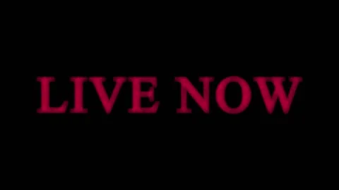 Bold red 'Live Now' text pulses with cinematic motion against a dark backgr.. Video stock 345620414