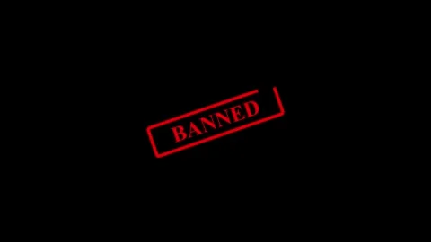 A bold red word banned displayed on a dark background. Banned word alert co.. Stock Footage 337567648