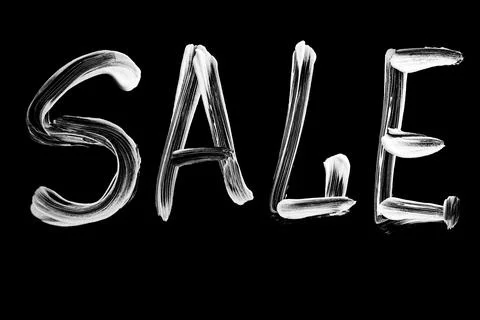 Bold white brush script word SALE for retail promotion on black background Stock Photos