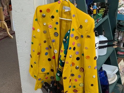 A bold yellow jacket covered in hundreds of colorful buttons Stock Photos