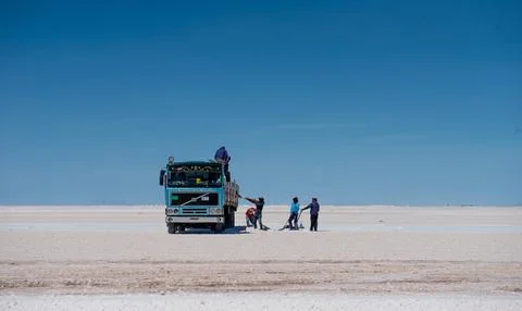 Bolivia - October 23, 2018: Workers gathering salt at salt flats Stock Photos