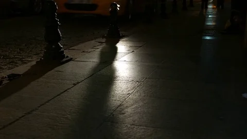 Bollard shadows slide over sidewalk tiles, Istanbul street in night time Stock Footage 83209325