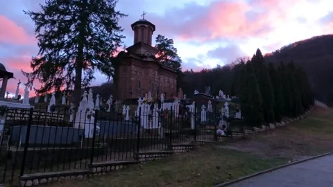 Bolnita Monastery with graveyard at dusk sunset colorful pink blue sky Video stock 168249896