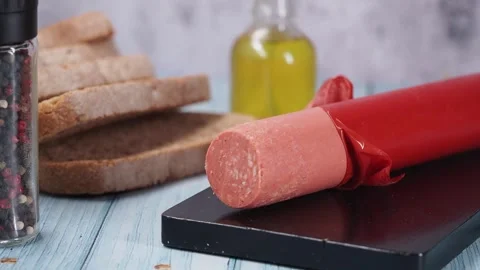 Bologna sausage with bread on a table Stock Footage 337127125