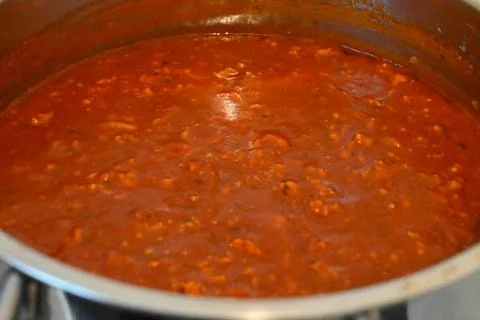 Bolognese sauce simmering in a pot Fotos Stock