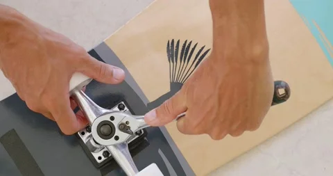 Bolt adjustment on a surf skate. Close-up hands with tool. Stock Footage 156295413