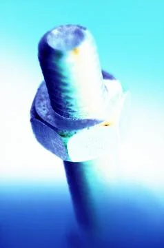 Bolt and Nut Close-Up in Abstract Blue Lighting Stock Photos