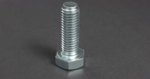 Bolt close-up on a dark background. Fastener. Stockbeeldmateriaal 164285361