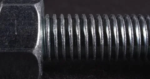 Bolt close-up on a dark background. Fastener. Видео 165265655