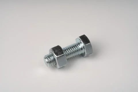 A bolt with a Closeup nut screwed on it. Stock Photos