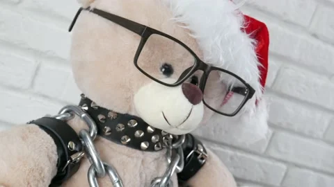 Bolt cutter with a chain on the background a toy Teddy bear dressed in leather Stock Footage 143455919
