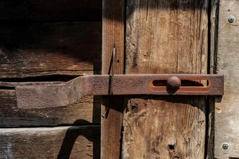 The bolt on the door of the barn. Stock Photos