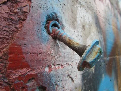A Bolt Falling Out of an Old Concrete Wall Stock Photos