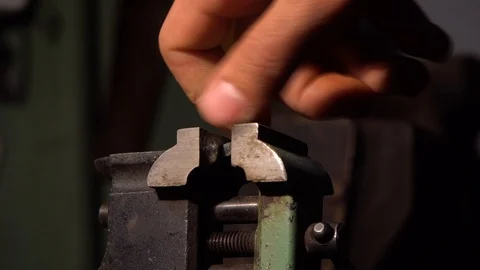 The bolt is fixed in an engineering vice,the arm tightens the nut on the bolt Stock Footage 126749318