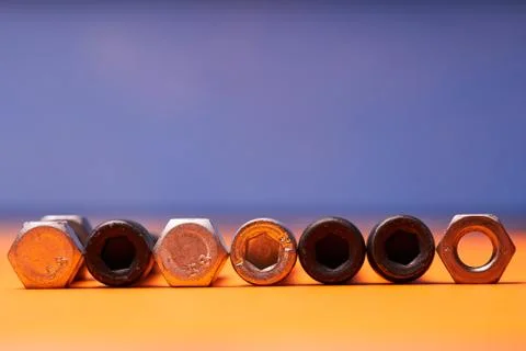 Bolted connecting elements on orange, blue background close-up Stock Photos