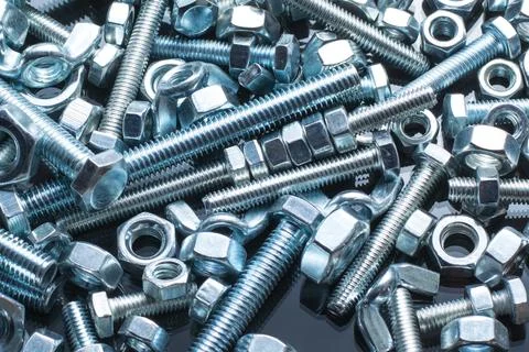 Bolts and nuts of different size Stock Photos