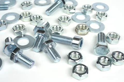 Bolts of different sizes with nuts on a white background Stock Photos