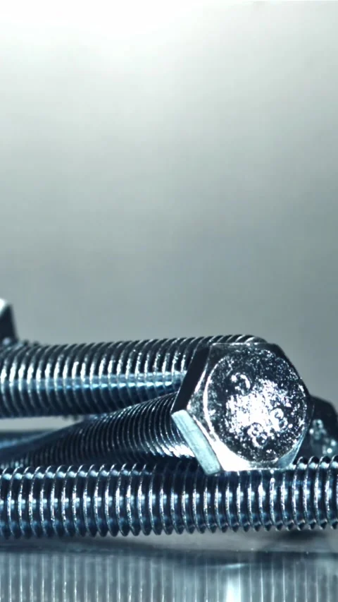 The bolts fall on the metal table. Filmed on a high-speed camera at 1000 fps Stock Footage 335378433