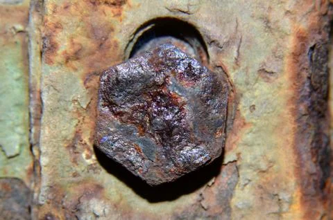 Bolts that have been rusty, blackish brown, pentagon shaped Stock Photos