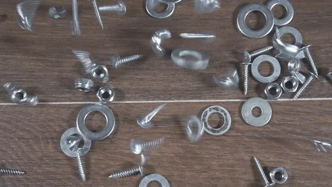 Bolts nuts screws fall on the table Stock Footage 101028293