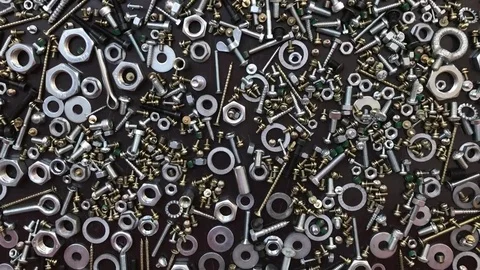 Bolts, screws and rivets on a table as a background Stock Footage 82364147
