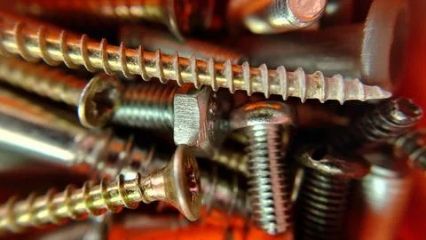 Bolts screws nuts of different sizes close up Stock Photos