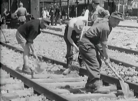 BOLZANO - 1945: Ballast work - Workers dig ballast between railway sleepers Stock Footage 343848908