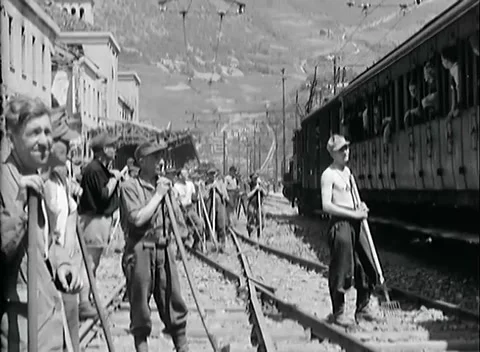 BOLZANO - 1945: Track workers - Work crews line the track beside a carriage Stock Footage 343848899