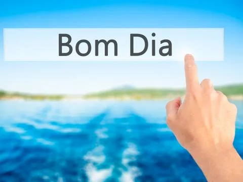 Bom Dia (In portuguese - Good Morning) - Hand pressing a button on blurred ba Stock Photos