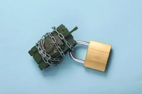 Bomb with chains and padlock on blue background Stock Photos