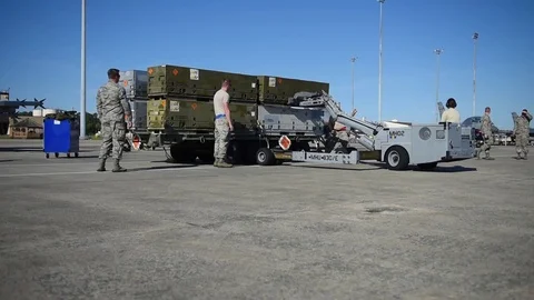Bomb loader unloading ammunition box for building and loading program with F-16 Stock Footage 83306890
